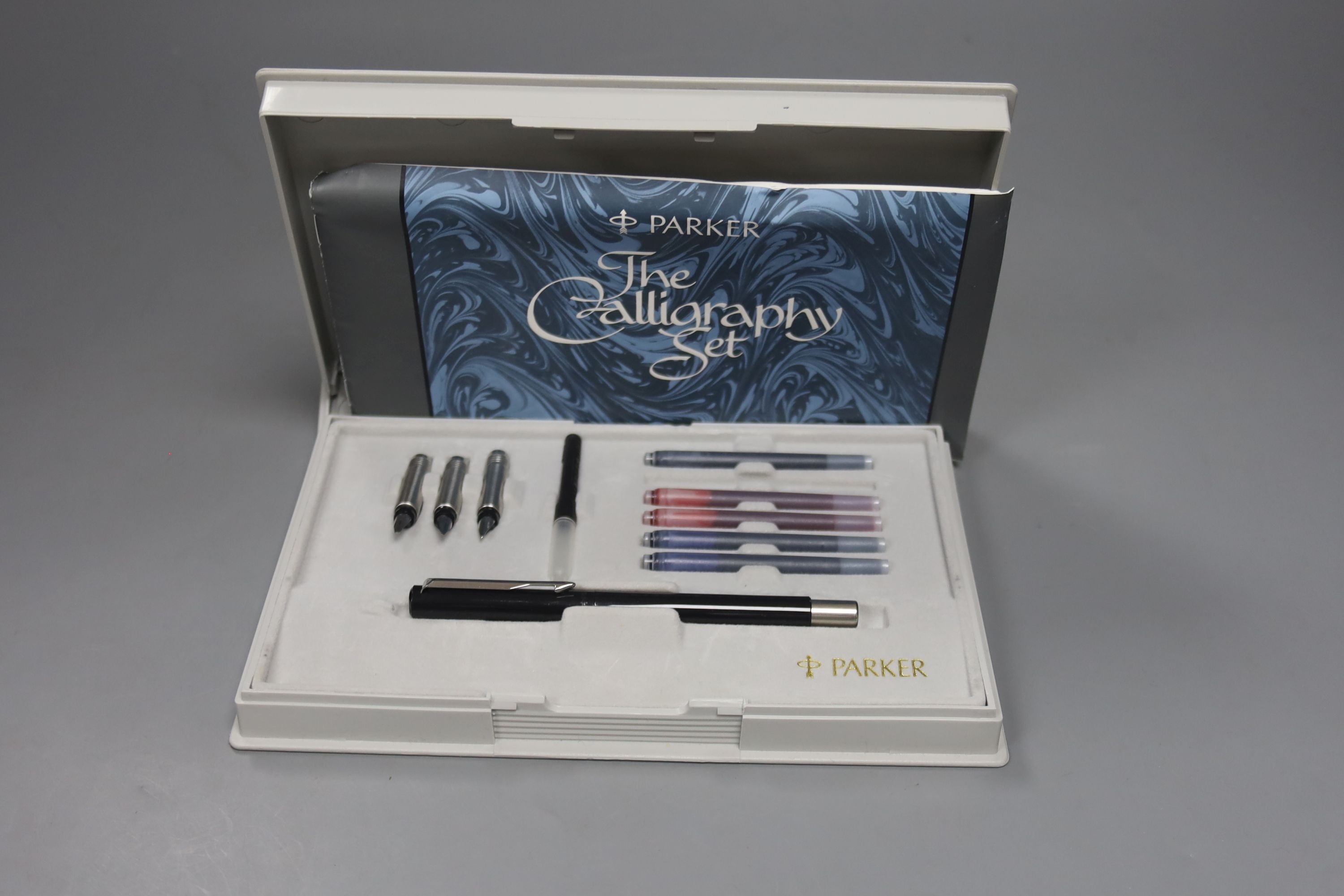 A Parker pen stand, boxed Parker Duofold and Parker Calligraphy set